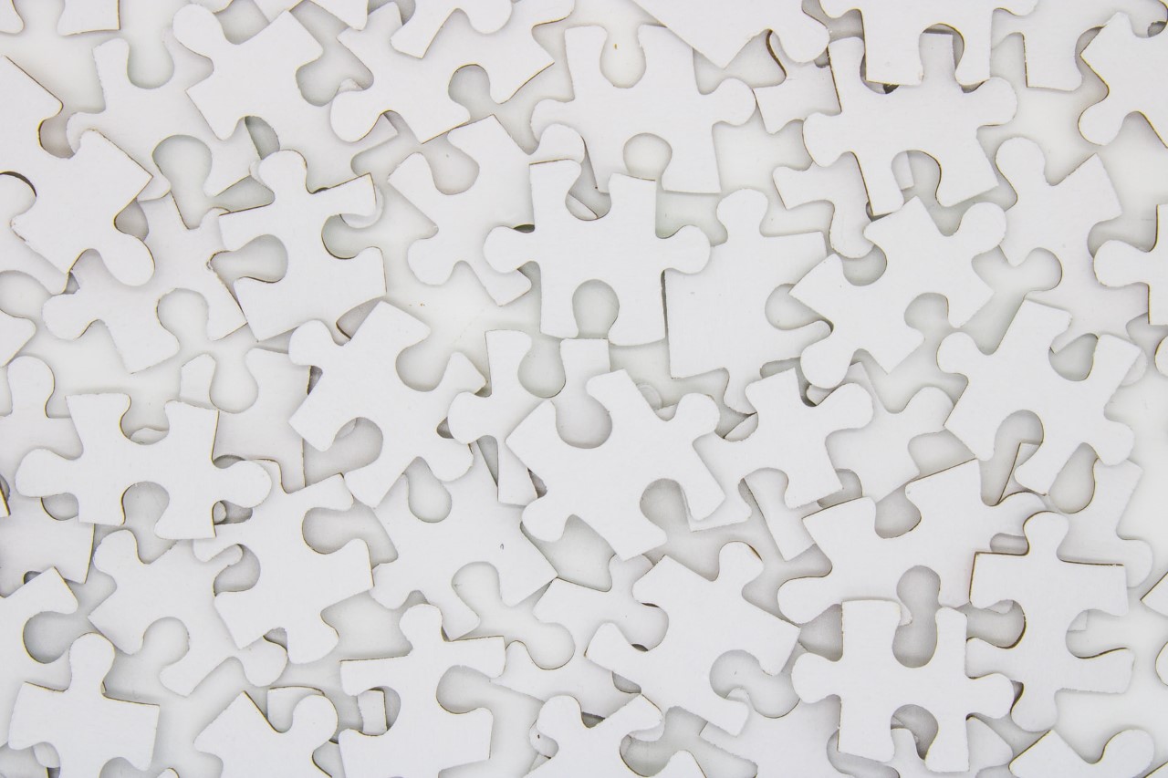 A close up of a white puzzle piece.