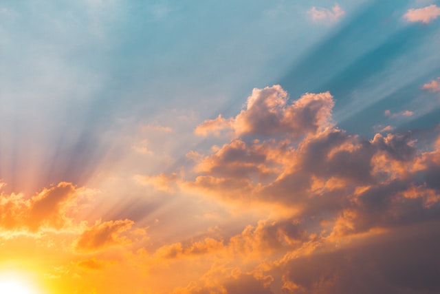 Sun shining through the clouds in the sky.